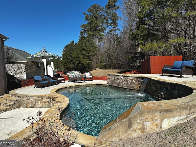 view of pool featuring a patio area, an outdoor hangout area, and pool water feature