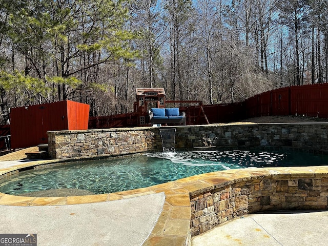 view of swimming pool with a playground