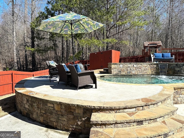 view of patio with pool water feature and a fenced in pool