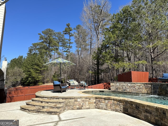 view of patio featuring pool water feature