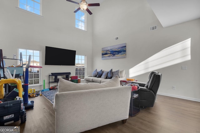 living room with ceiling fan and wood-type flooring