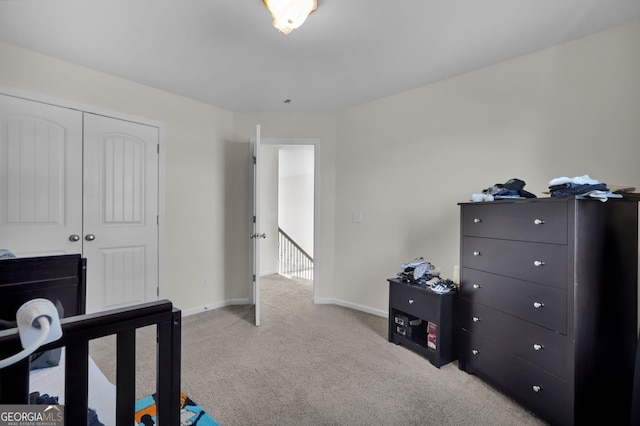 bedroom featuring light carpet and a closet