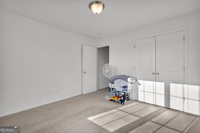 unfurnished bedroom featuring carpet and a closet