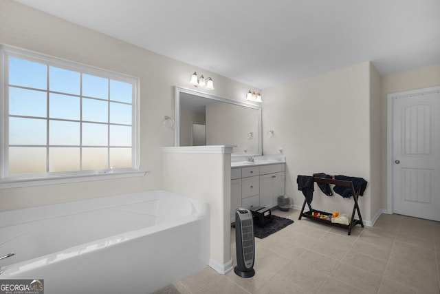 bathroom with vanity, tile patterned flooring, and a bath