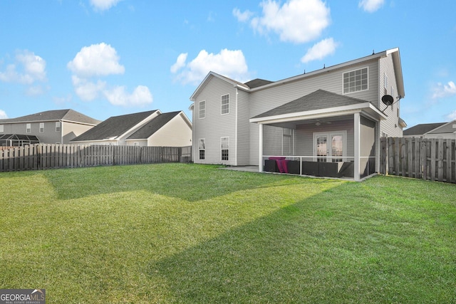 back of house with a patio and a lawn