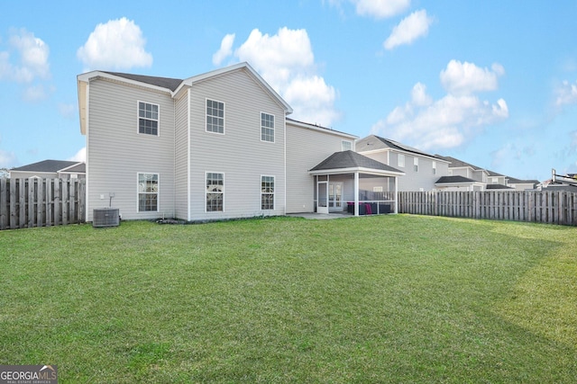 back of property with a patio, a lawn, and central air condition unit