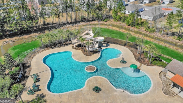 view of pool with a patio and a water slide