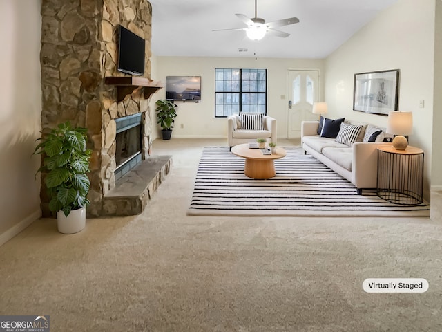 carpeted living room featuring lofted ceiling, visible vents, ceiling fan, a stone fireplace, and baseboards