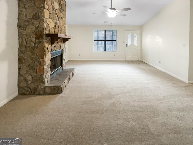 unfurnished living room featuring carpet floors, a fireplace, lofted ceiling, a ceiling fan, and baseboards