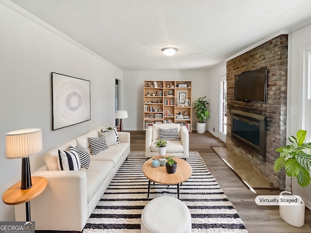 living room featuring a fireplace, crown molding, and dark hardwood / wood-style flooring