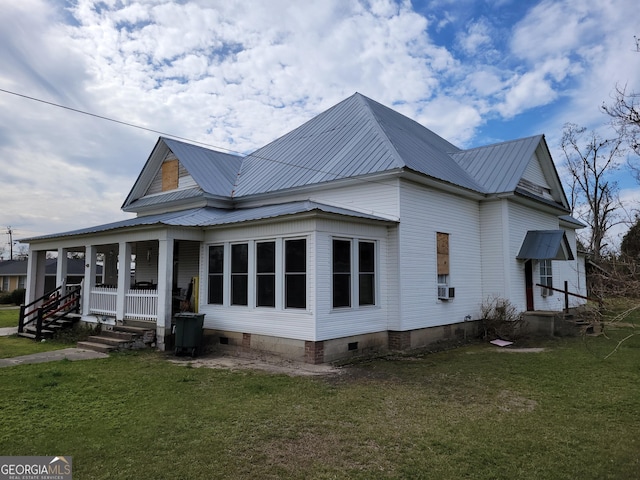 view of property exterior with covered porch and a lawn