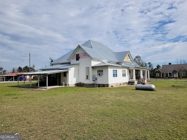 back of property featuring a yard