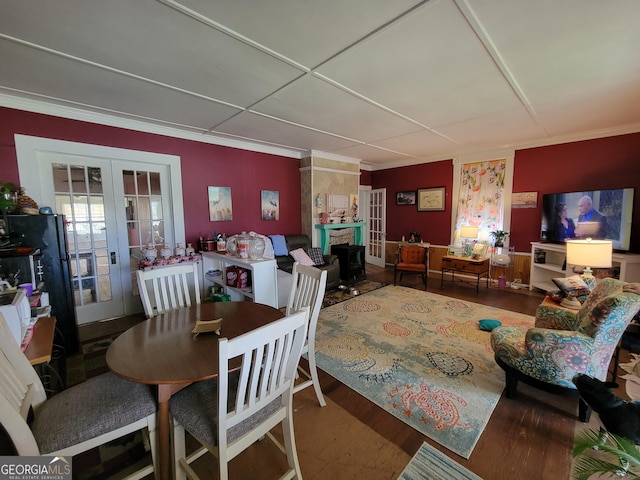 dining room featuring french doors, hardwood / wood-style floors, and crown molding