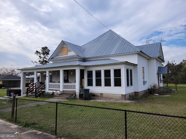 view of front of home with covered porch and a front yard