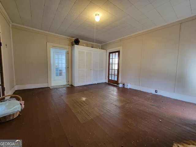 interior space with dark hardwood / wood-style flooring and crown molding