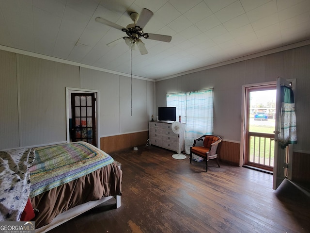 bedroom with crown molding, dark wood-type flooring, and ceiling fan