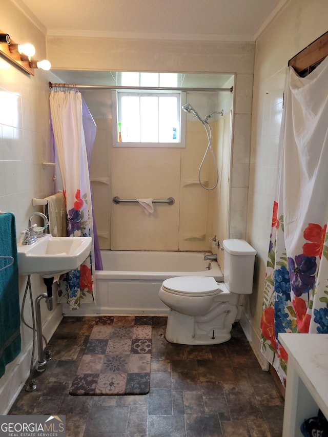 full bathroom with sink, tile walls, toilet, and shower / tub combo