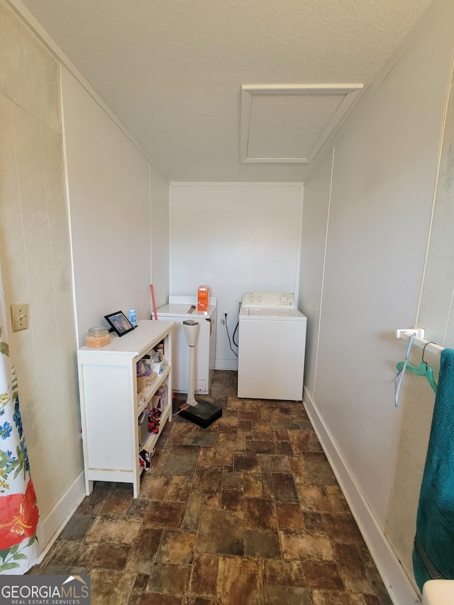 clothes washing area featuring washer / dryer