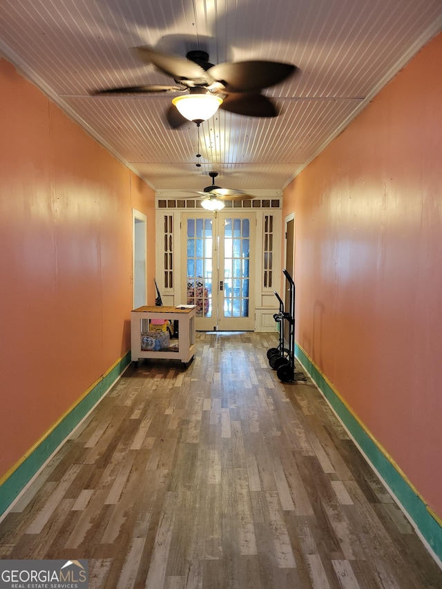 exercise room with wood ceiling, crown molding, french doors, and hardwood / wood-style floors