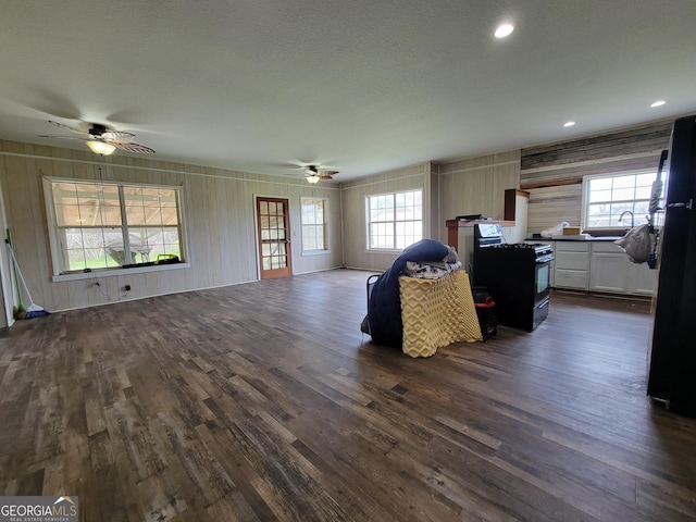 living room with ceiling fan, sink, dark hardwood / wood-style floors, and a healthy amount of sunlight