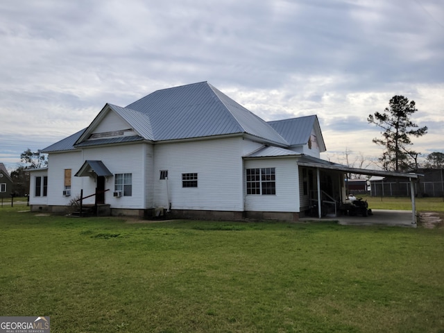 view of side of property with a yard and a carport