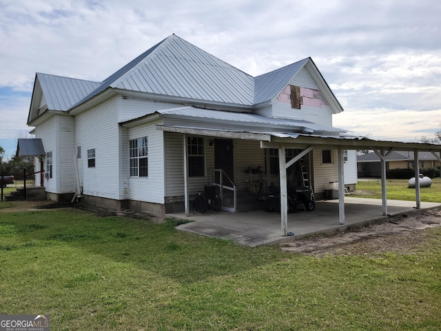 rear view of property with a yard