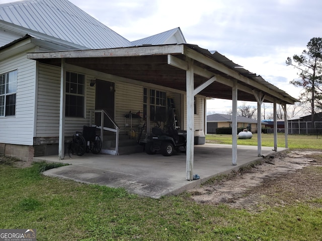 view of parking with a lawn and a carport