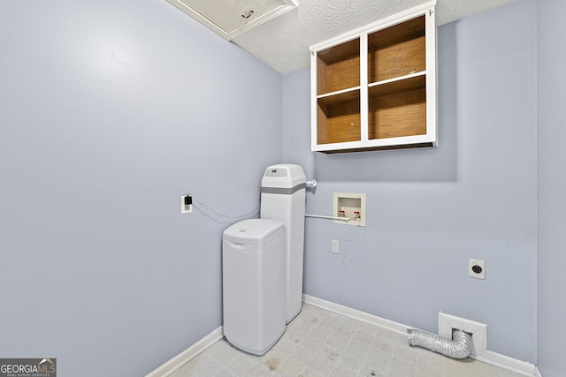 laundry area with a textured ceiling, hookup for an electric dryer, and washer hookup