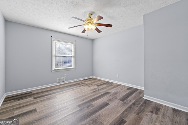 unfurnished room featuring a textured ceiling, ceiling fan, and dark hardwood / wood-style floors