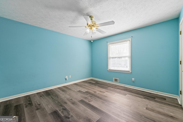 empty room featuring hardwood / wood-style floors, ceiling fan, and a textured ceiling