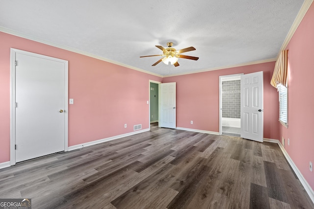 unfurnished bedroom featuring a textured ceiling, ornamental molding, hardwood / wood-style floors, and ensuite bath