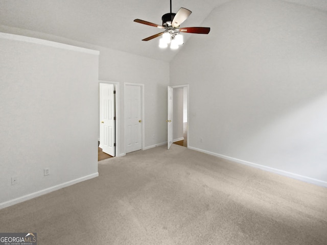 unfurnished bedroom featuring high vaulted ceiling, ceiling fan, baseboards, and carpet flooring