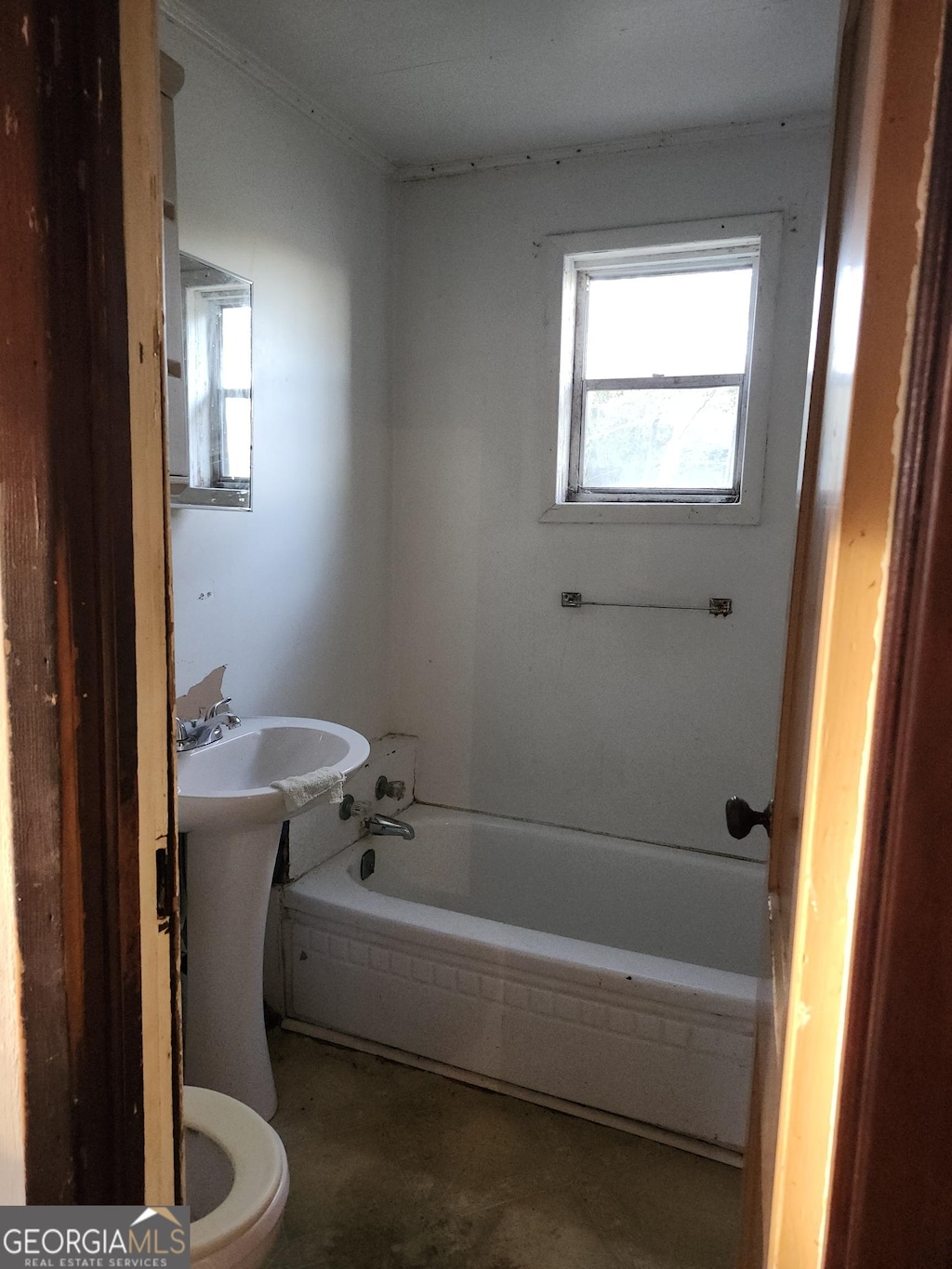 bathroom featuring toilet and a tub