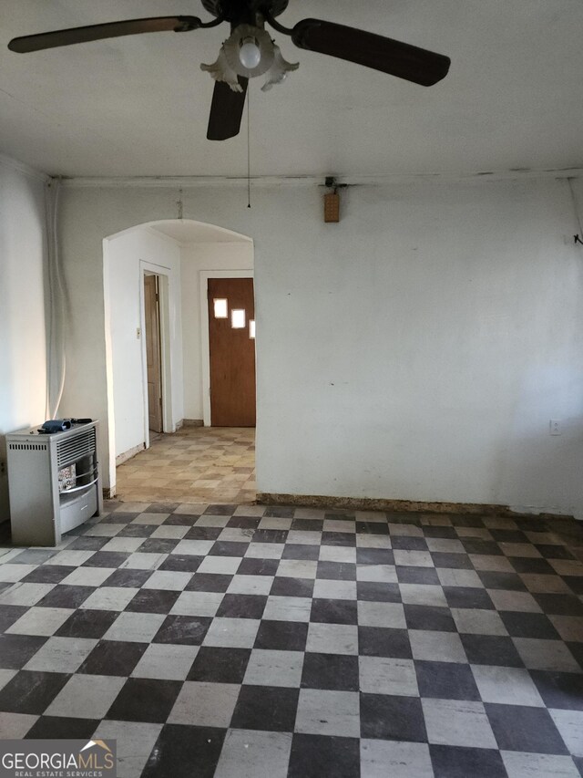 1121 Carroll St, Macon, GA 31206 - spare room with arched walkways, a ceiling fan, and tile patterned floors
