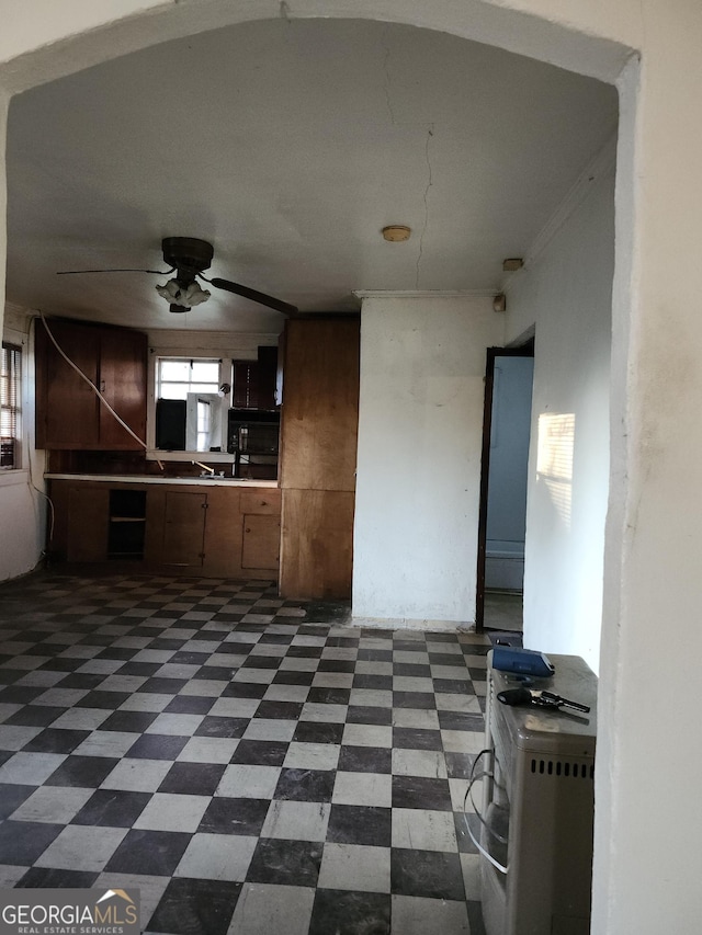 1121 Carroll St, Macon, GA 31206 - kitchen with dark floors and ceiling fan