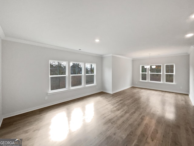 unfurnished living room featuring ornamental molding, dark wood finished floors, and baseboards