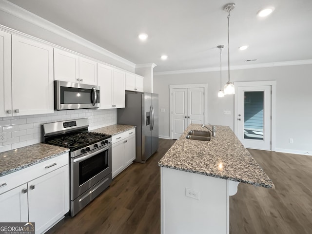 2976 Rambler Dr, Loganville, GA 30052 - kitchen with appliances with stainless steel finishes, ornamental molding, white cabinetry, dark wood-type flooring, and tasteful backsplash