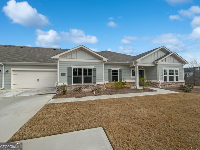 craftsman-style home with driveway, board and batten siding, and brick siding