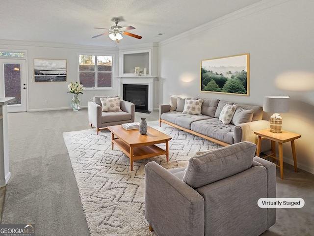 living area featuring crown molding, a fireplace with flush hearth, light carpet, ceiling fan, and baseboards