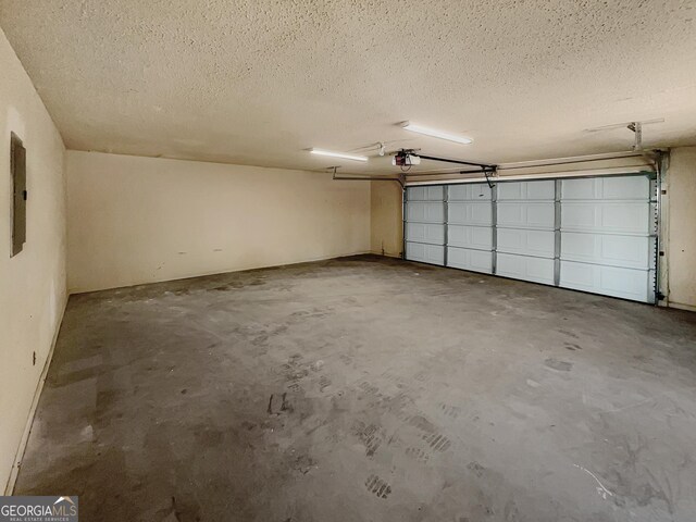 garage with electric panel and a garage door opener