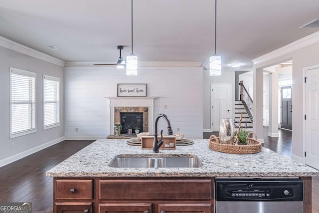 kitchen with crown molding, pendant lighting, sink, and stainless steel dishwasher