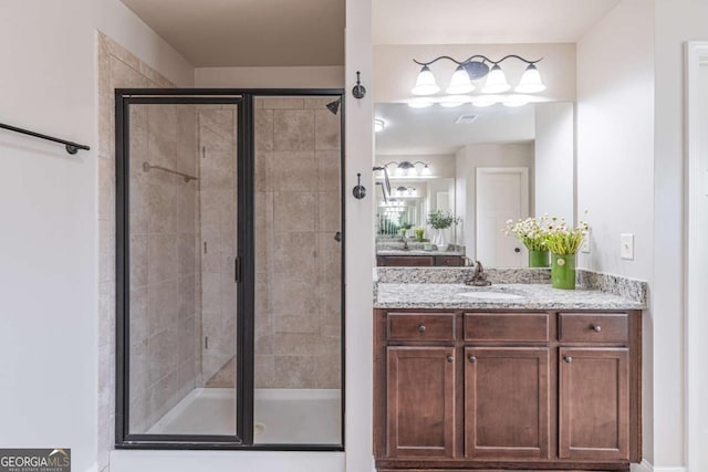 bathroom featuring vanity and a shower with shower door