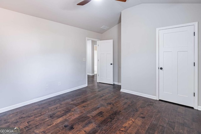 unfurnished bedroom with ceiling fan, dark wood-type flooring, and vaulted ceiling