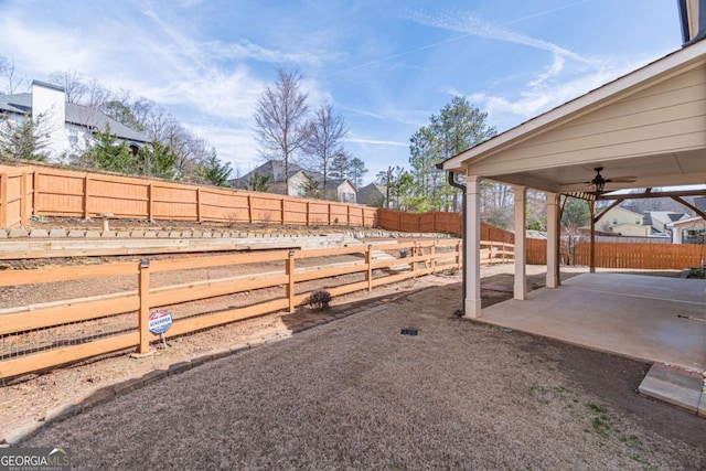 view of yard featuring ceiling fan and a patio