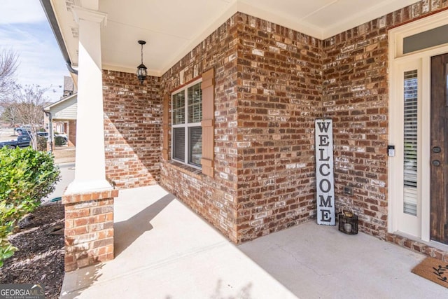 view of exterior entry with a porch