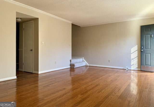 6900 Roswell Rd Unit 7N, Atlanta, GA 30328 - spare room featuring stairs, ornamental molding, a textured ceiling, and wood finished floors