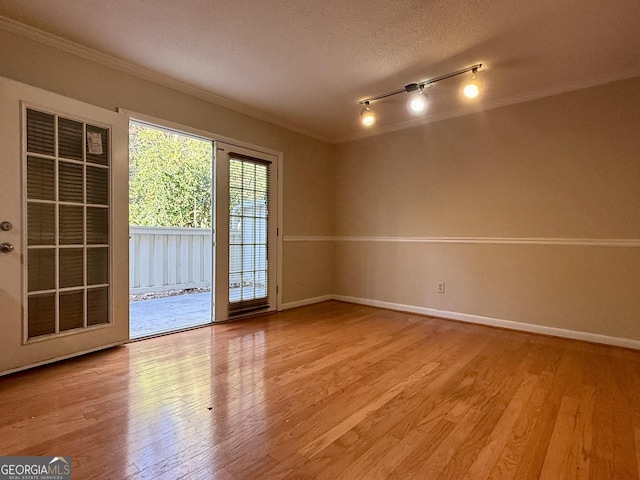6900 Roswell Rd Unit 7N, Atlanta, GA 30328 - unfurnished room featuring baseboards, light wood finished floors, and crown molding