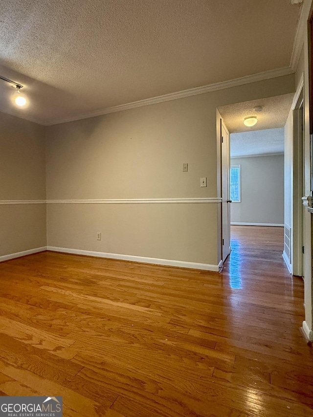 6900 Roswell Rd Unit 7N, Atlanta, GA 30328 - spare room featuring baseboards, visible vents, wood finished floors, crown molding, and a textured ceiling