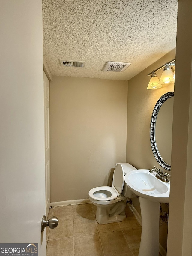 6900 Roswell Rd Unit 7N, Atlanta, GA 30328 - half bathroom with toilet, a textured ceiling, tile patterned flooring, and visible vents