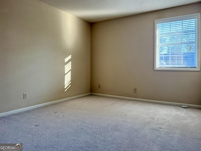 6900 Roswell Rd Unit 7N, Atlanta, GA 30328 - empty room with light colored carpet, a textured ceiling, and baseboards